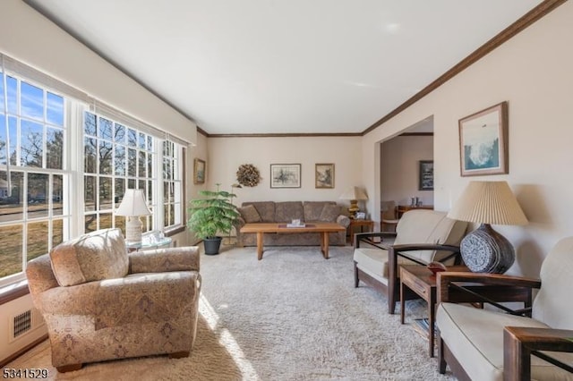 living area with carpet floors, visible vents, and crown molding