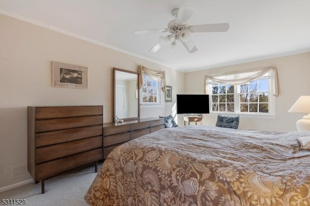 bedroom featuring crown molding, a ceiling fan, and carpet flooring