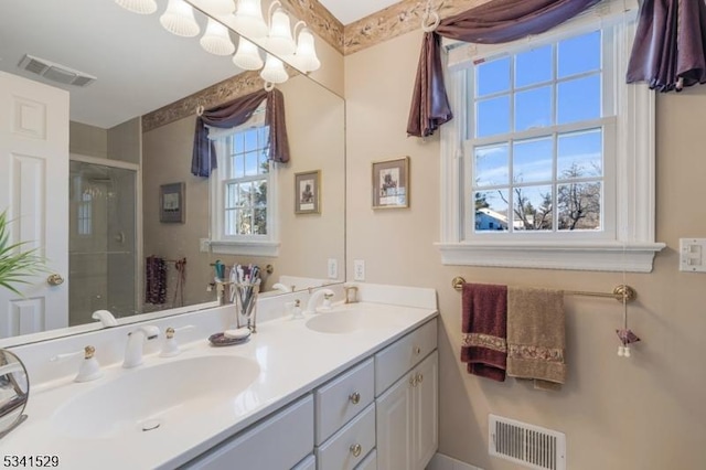 full bathroom featuring a stall shower, visible vents, and a sink