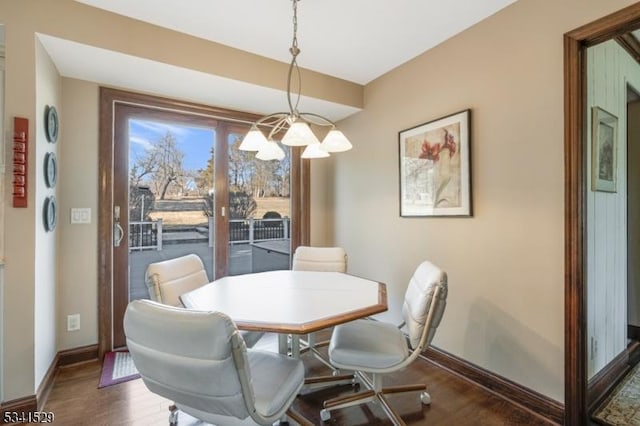 dining area featuring dark wood-style floors, french doors, and baseboards