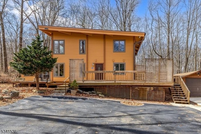 view of front of house featuring a garage and a wooden deck