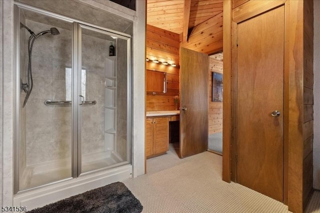 bathroom with a stall shower, wooden walls, wooden ceiling, vanity, and beam ceiling