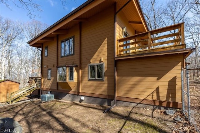 back of house with fence and central air condition unit