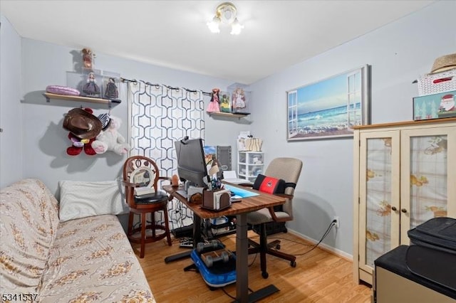 office area with baseboards, wood finished floors, and french doors