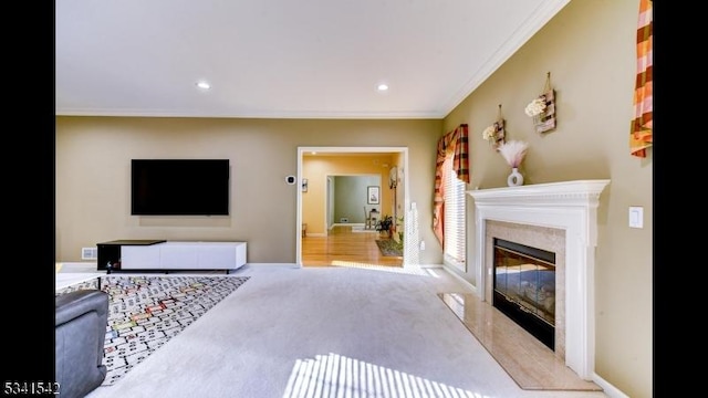 living area with a fireplace, recessed lighting, ornamental molding, carpet flooring, and baseboards