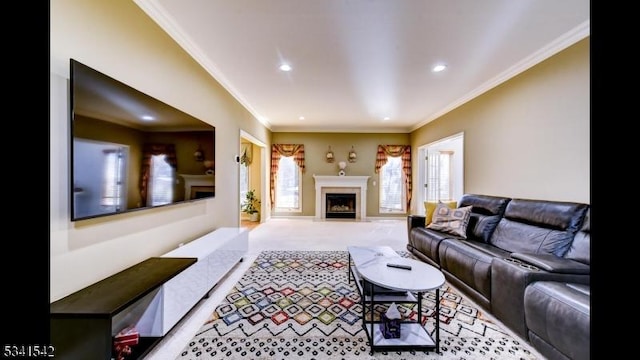 living room with ornamental molding, recessed lighting, light colored carpet, and a fireplace