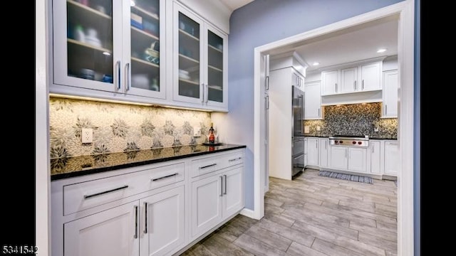 interior space featuring stainless steel appliances, recessed lighting, light wood-style floors, and decorative backsplash