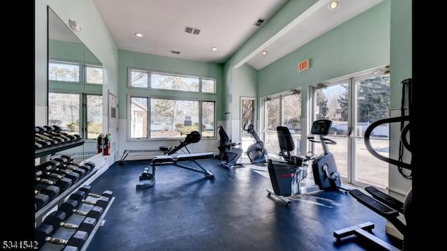 workout area with high vaulted ceiling, visible vents, and recessed lighting