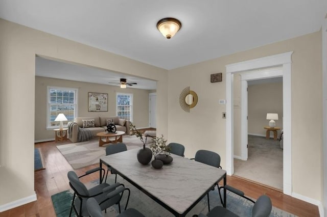 dining space with baseboards and wood finished floors