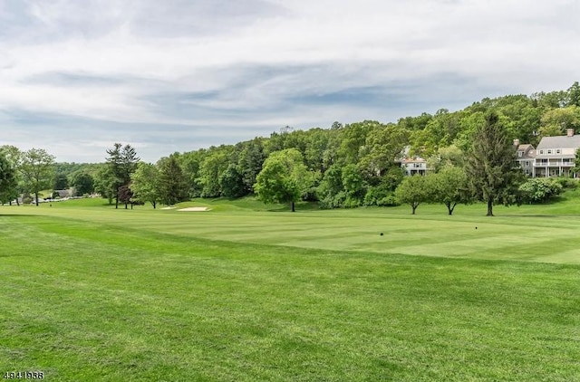 view of home's community with a lawn and golf course view