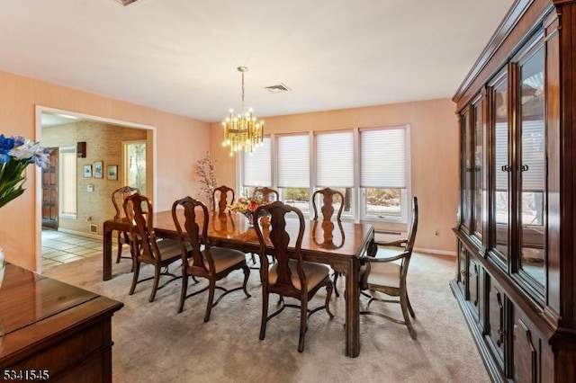 dining area with visible vents, baseboard heating, light carpet, a chandelier, and baseboards