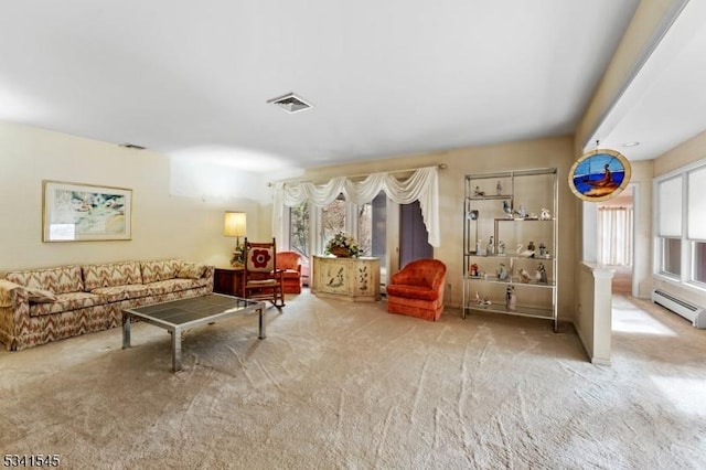 living room featuring a baseboard heating unit, visible vents, and carpet flooring