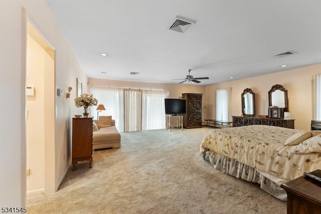 bedroom featuring a ceiling fan, a baseboard radiator, visible vents, and light carpet