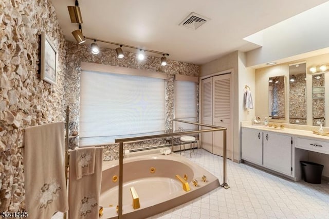 full bath featuring a jetted tub, visible vents, and vanity