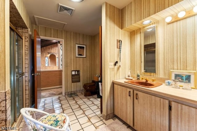 full bath featuring tile patterned floors, vanity, visible vents, and wallpapered walls