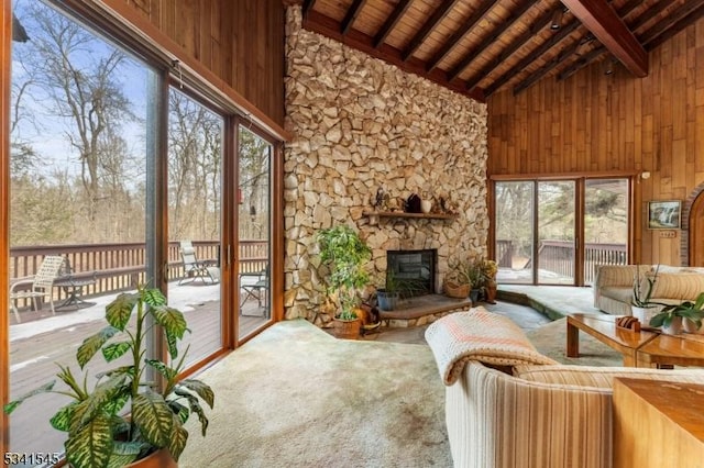 sunroom featuring vaulted ceiling with beams and wood ceiling