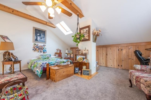 carpeted bedroom featuring a skylight, high vaulted ceiling, and beam ceiling