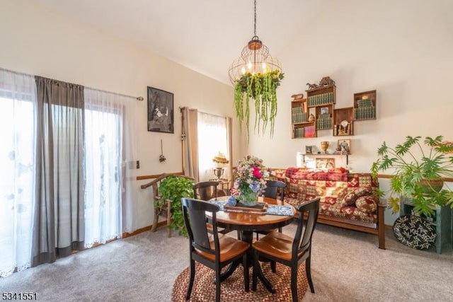 dining space with a chandelier and carpet floors