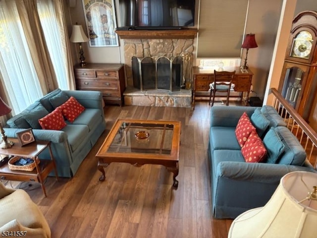 living room with a fireplace and wood finished floors