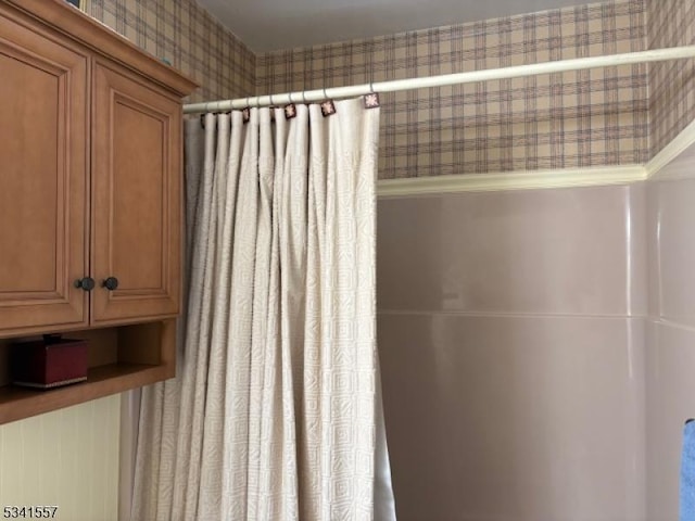 bathroom featuring wallpapered walls