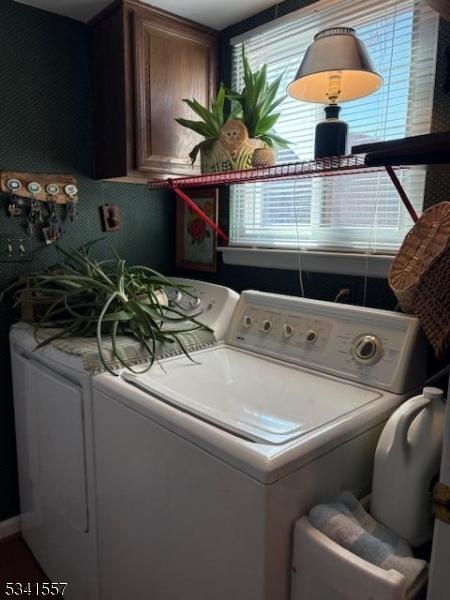 laundry area featuring washer and dryer and cabinet space