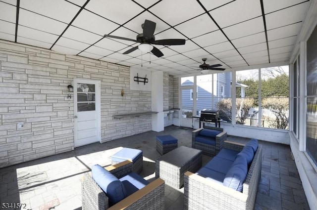 view of patio / terrace with ceiling fan, a grill, and an outdoor living space