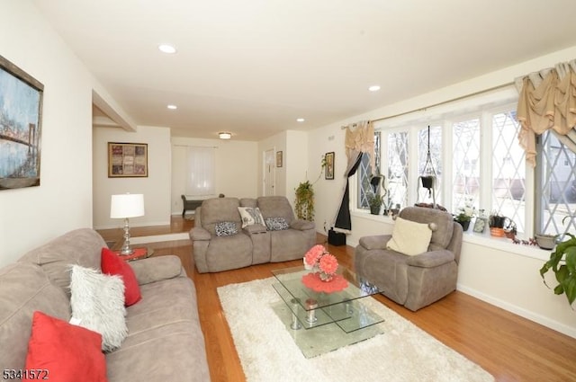 living room featuring recessed lighting, baseboards, and wood finished floors