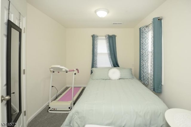 bedroom featuring carpet flooring, visible vents, and baseboards