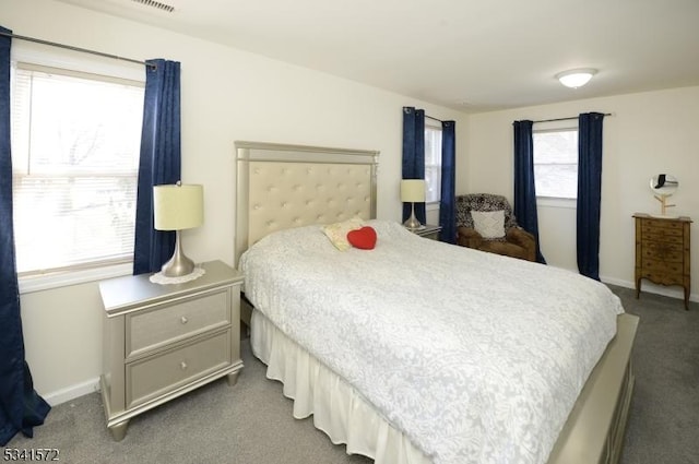 carpeted bedroom featuring baseboards