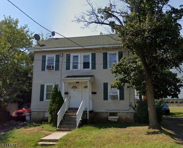 colonial-style house with a front lawn