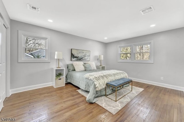 bedroom featuring recessed lighting, wood-type flooring, visible vents, and baseboards