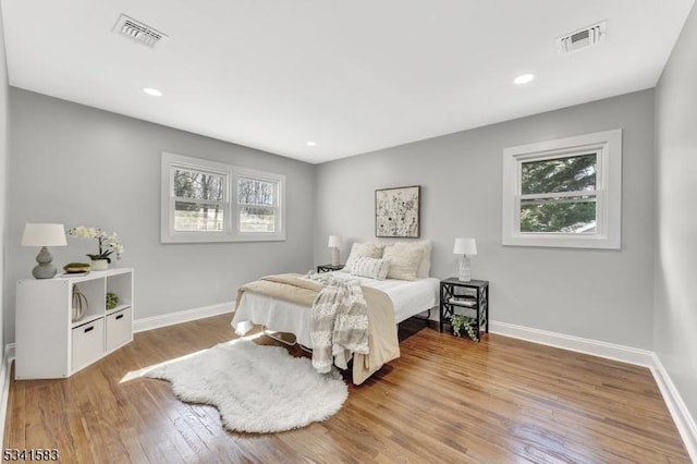 bedroom with baseboards, multiple windows, and visible vents