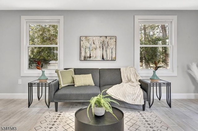 living room featuring wood tiled floor and baseboards