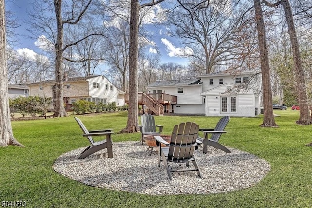 view of yard featuring an outdoor fire pit, a wooden deck, stairway, and french doors