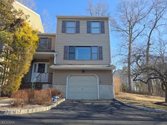 view of front of property featuring aphalt driveway and an attached garage