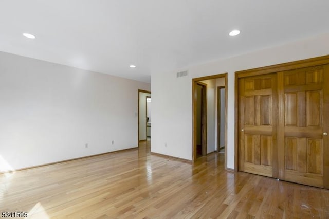 unfurnished bedroom with visible vents, baseboards, light wood finished floors, recessed lighting, and a closet