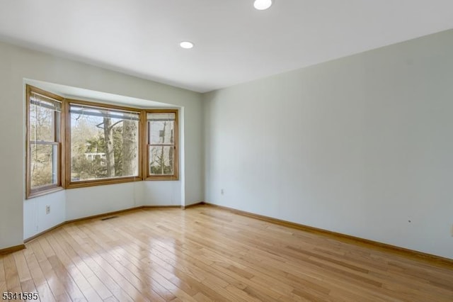 unfurnished room featuring visible vents, recessed lighting, baseboards, and light wood-style floors