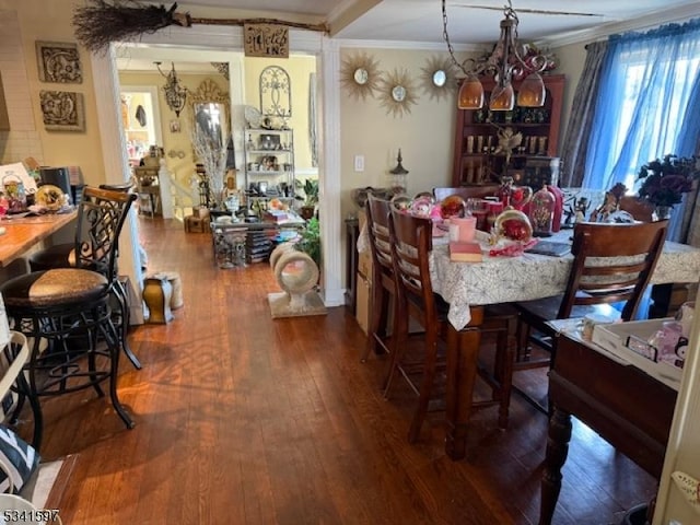 dining area featuring hardwood / wood-style floors and crown molding