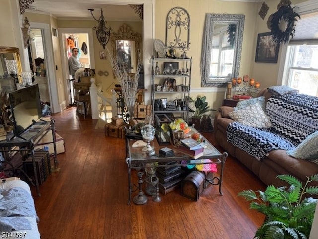 living area with ornamental molding and hardwood / wood-style flooring