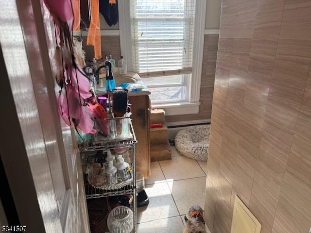 bathroom featuring tile patterned flooring and tile walls