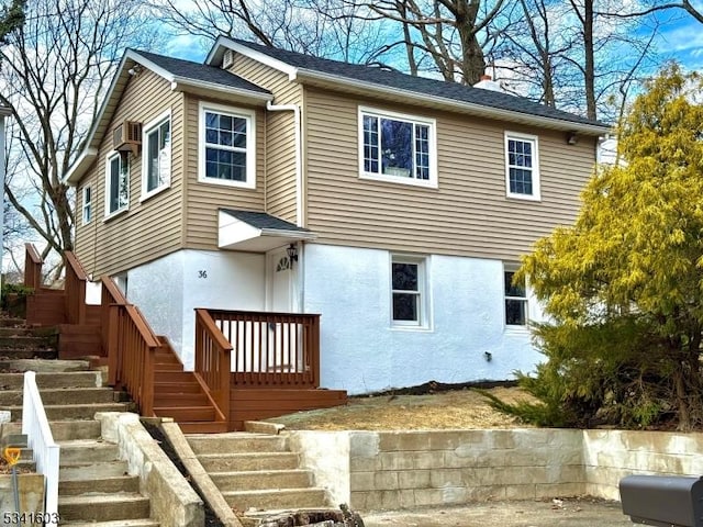 view of front of house featuring stairway and stucco siding