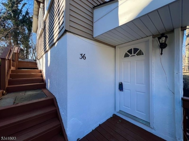 entrance to property with stucco siding