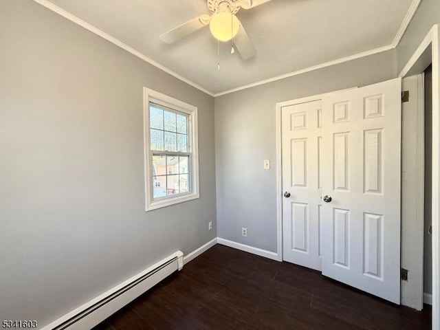 unfurnished bedroom with dark wood-style flooring, crown molding, a baseboard radiator, a ceiling fan, and baseboards