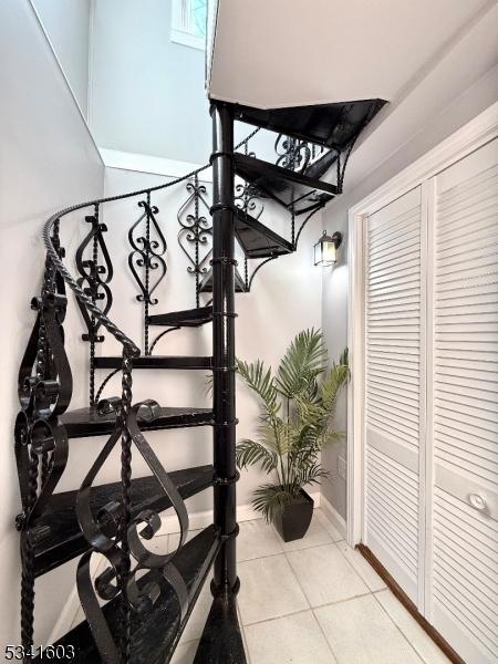 stairs featuring tile patterned flooring