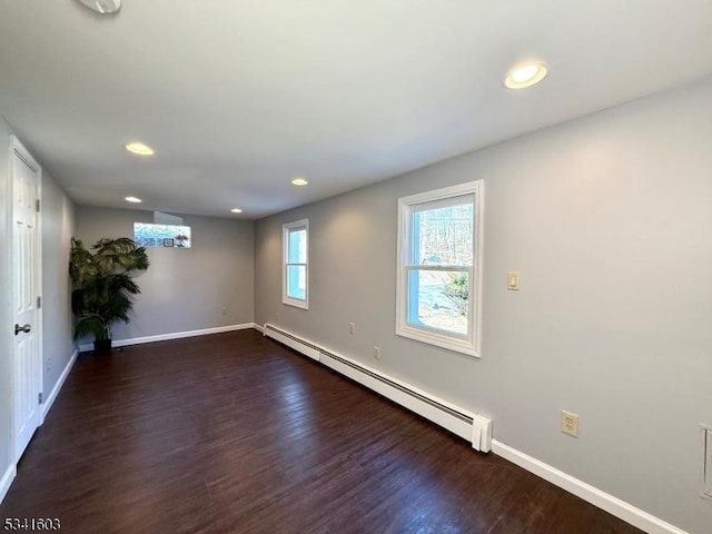 spare room with recessed lighting, a baseboard radiator, dark wood finished floors, and baseboards