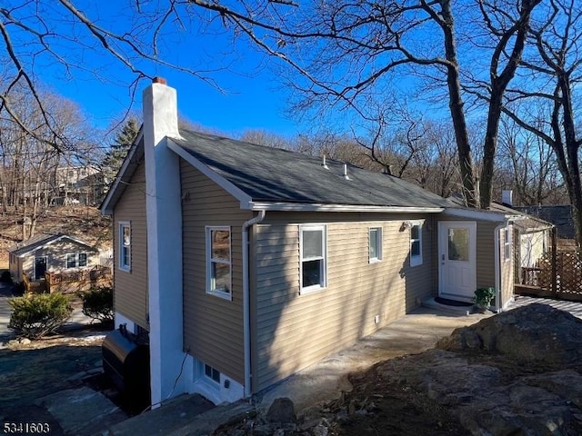 view of property exterior featuring a chimney