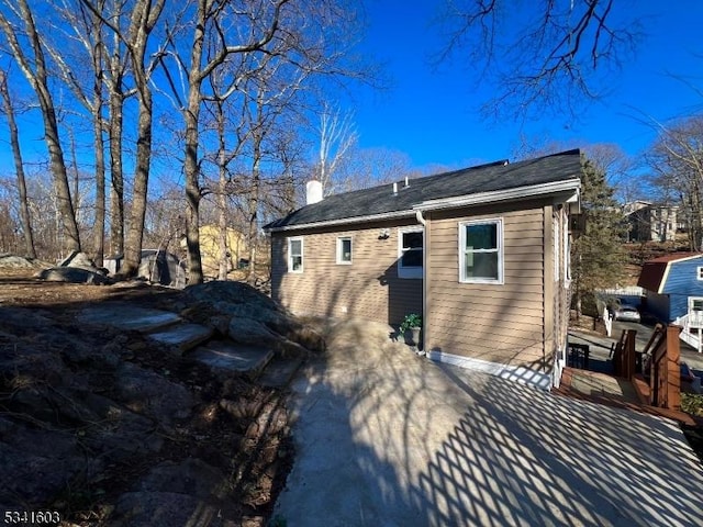 rear view of property with a chimney