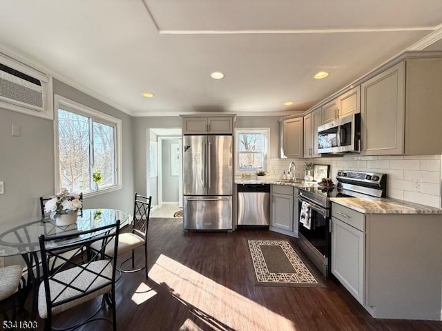 kitchen featuring stainless steel appliances, gray cabinets, and dark wood finished floors