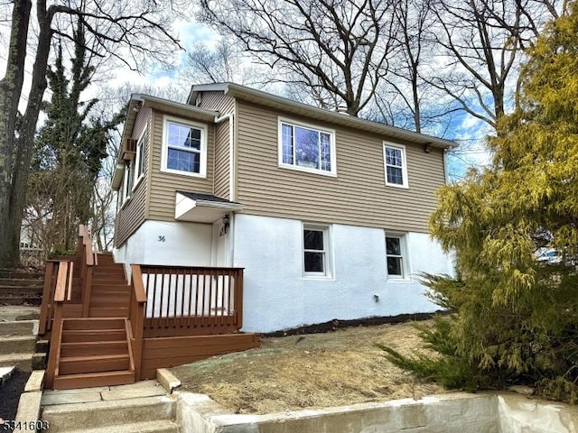 exterior space featuring stairs and stucco siding