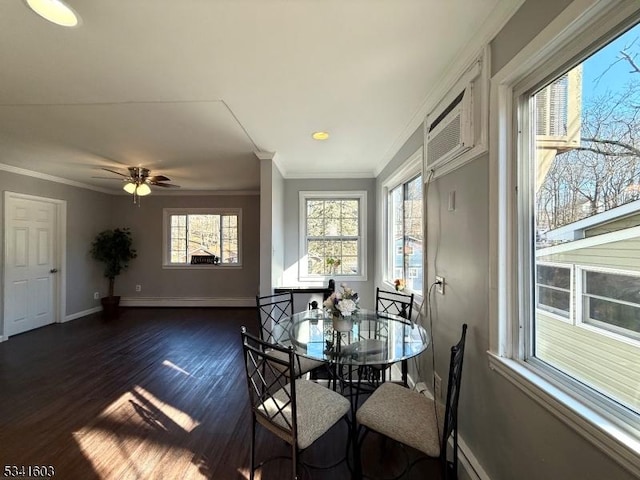 dining room featuring dark wood-style flooring, crown molding, baseboard heating, an AC wall unit, and baseboards